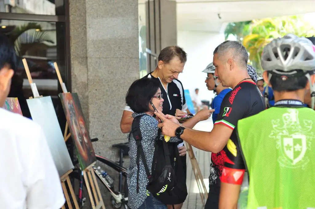 Participants of the ride taking a break while enjoying the exhibition at Hilton Kuching.