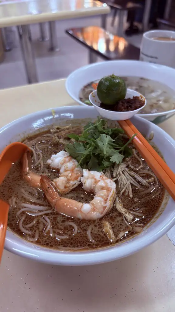 Bowl of Sarawak Laksa from the Bedok stall, featuring prawns, chicken and smooth beehoon.