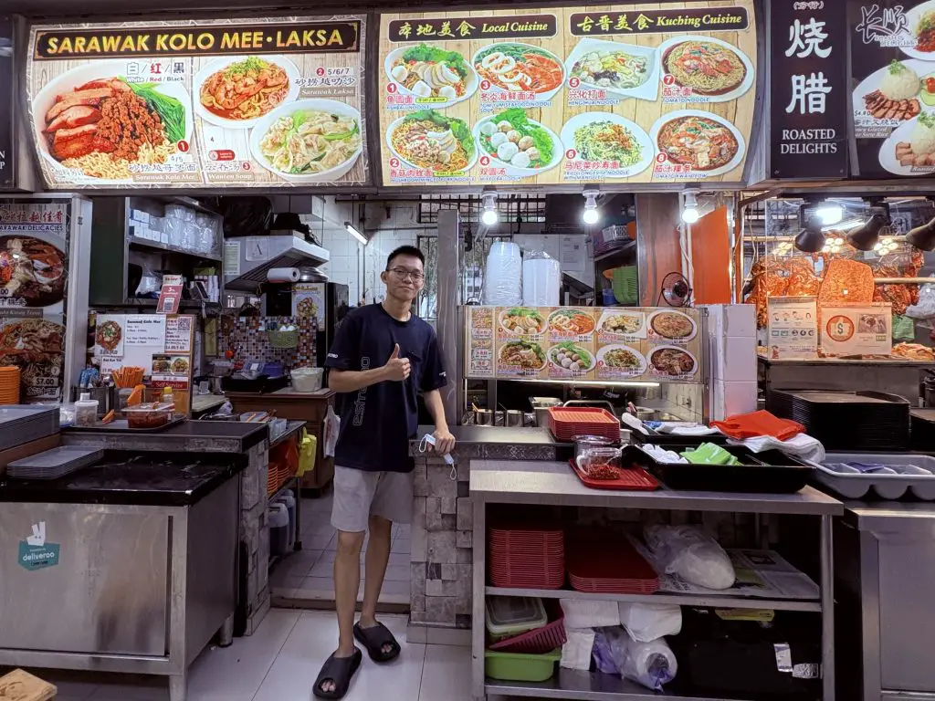 Jong, the 18-year-old godson of the owner, standing in front of the new stall at Bedok.